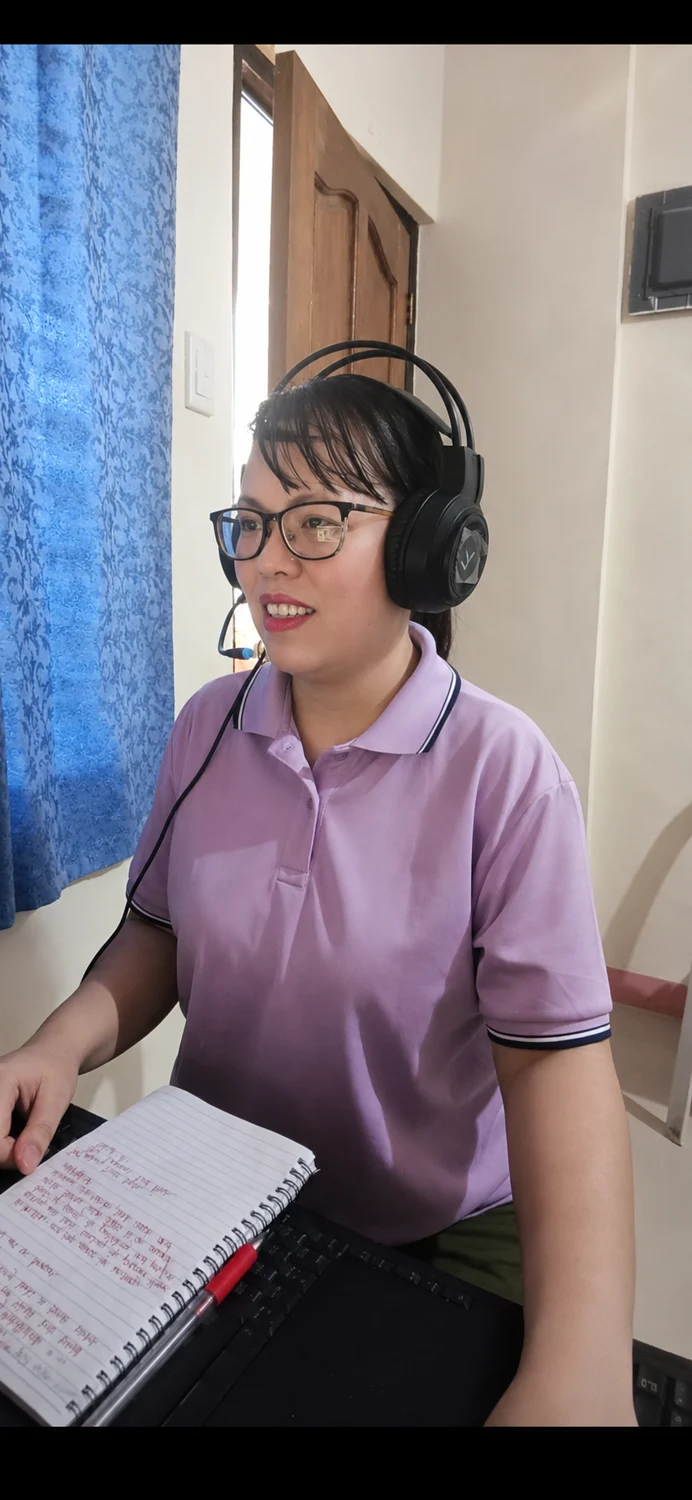 Jeyy Eem wearing a headset while working at her desk